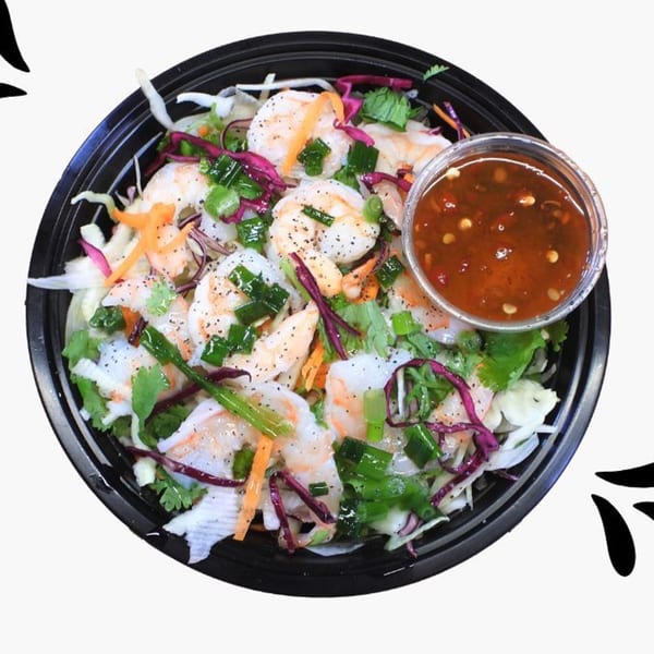 Shrimp salad with shredded cabbage, carrots, herbs, and a side of chili sauce from Pho Go.